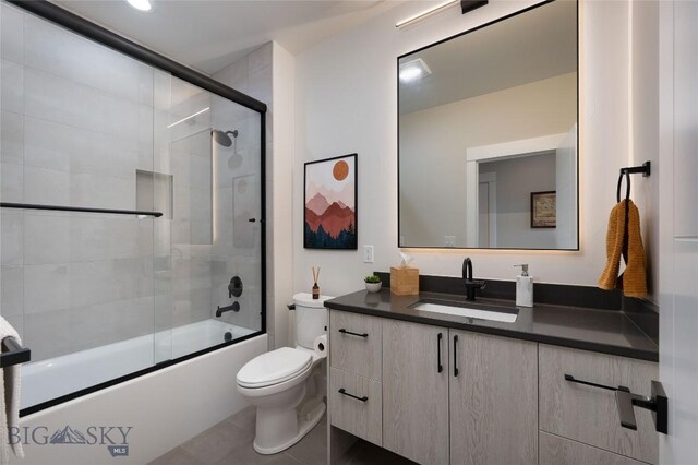 1510 Windrow Dr, Bozeman, MT 59718 - full bath featuring vanity, toilet, combined bath / shower with glass door, and tile patterned floors