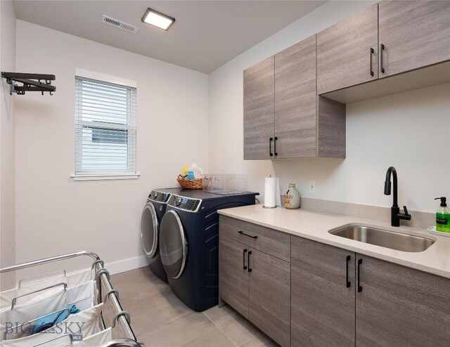 1510 Windrow Dr, Bozeman, MT 59718 - laundry area with cabinet space, independent washer and dryer, light tile patterned floors, and baseboards