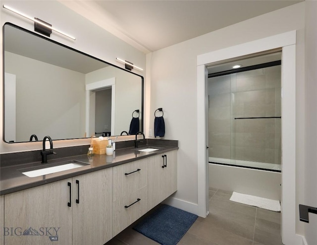 1510 Windrow Dr, Bozeman, MT 59718 - bathroom featuring double vanity, tile patterned floors, baseboards, and combined bath / shower with glass door