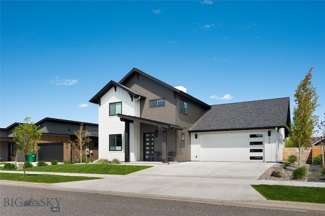 1510 Windrow Dr, Bozeman, MT 59718 - contemporary house with a garage, driveway, board and batten siding, and a front yard