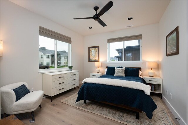 1510 Windrow Dr, Bozeman, MT 59718 - bedroom featuring multiple windows, light wood-style floors, a ceiling fan, baseboards, and recessed lighting