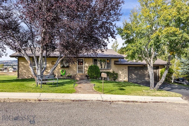 34 Mammoth, Butte, MT 59701 - view of front of property featuring driveway, an attached garage, stucco siding, and a front lawn