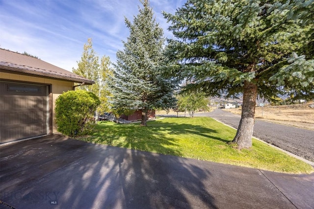 34 Mammoth, Butte, MT 59701 - view of green lawn featuring driveway and a garage