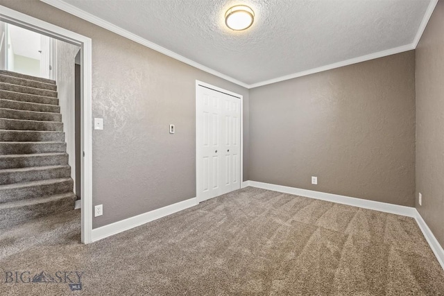 34 Mammoth, Butte, MT 59701 - carpeted spare room featuring a textured ceiling, a textured wall, ornamental molding, stairway, and baseboards