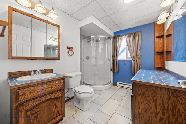 34 Mammoth, Butte, MT 59701 - full bathroom with baseboard heating, a stall shower, vanity, toilet, and a drop ceiling