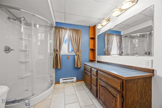 34 Mammoth, Butte, MT 59701 - bathroom with a shower stall, a baseboard radiator, vanity, marble look tile flooring, and baseboards