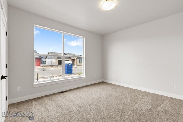 608 Spaniel Ln, Belgrade, MT 59714 - empty room featuring baseboards and carpet flooring