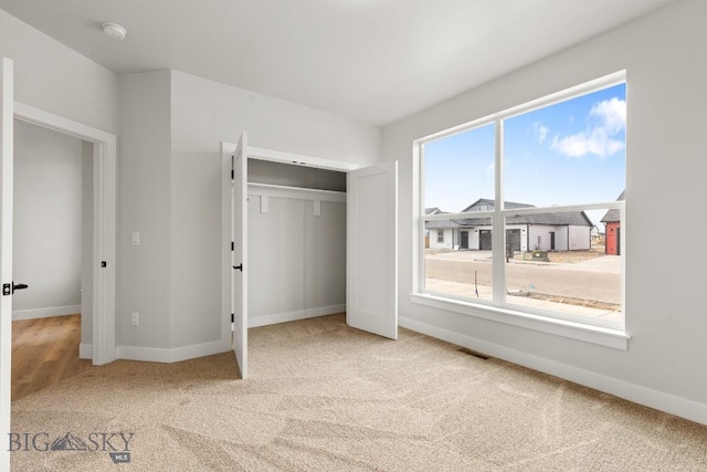 608 Spaniel Ln, Belgrade, MT 59714 - unfurnished bedroom with carpet floors, baseboards, and a closet