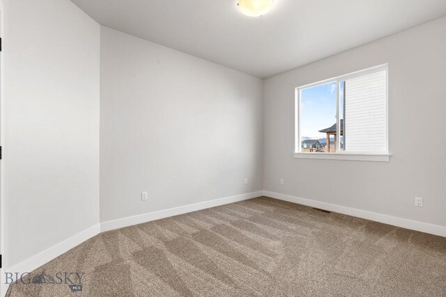 608 Spaniel Ln, Belgrade, MT 59714 - empty room featuring carpet floors and baseboards