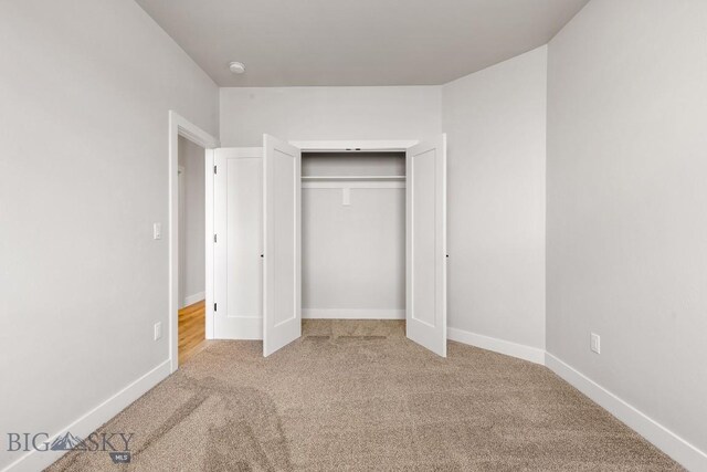 608 Spaniel Ln, Belgrade, MT 59714 - unfurnished bedroom featuring carpet, baseboards, and a closet