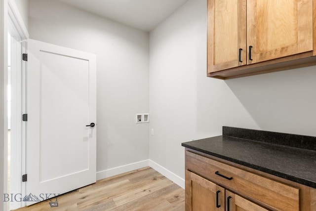 608 Spaniel Ln, Belgrade, MT 59714 - washroom with cabinet space, light wood finished floors, baseboards, and hookup for a washing machine