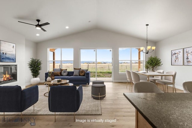 608 Spaniel Ln, Belgrade, MT 59714 - living room with vaulted ceiling, plenty of natural light, light wood-style floors, a chandelier, and recessed lighting