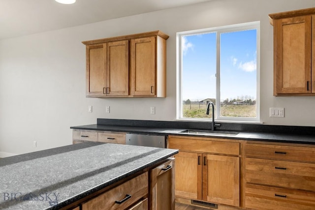 608 Spaniel Ln, Belgrade, MT 59714 - kitchen with a sink, dishwasher, and brown cabinetry