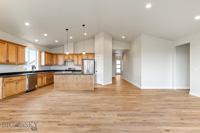 608 Spaniel Ln, Belgrade, MT 59714 - kitchen featuring stainless steel appliances, dark countertops, light wood-style floors, recessed lighting, and vaulted ceiling