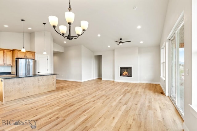608 Spaniel Ln, Belgrade, MT 59714 - unfurnished living room featuring recessed lighting, light wood-style flooring, ceiling fan, baseboards, and a glass covered fireplace
