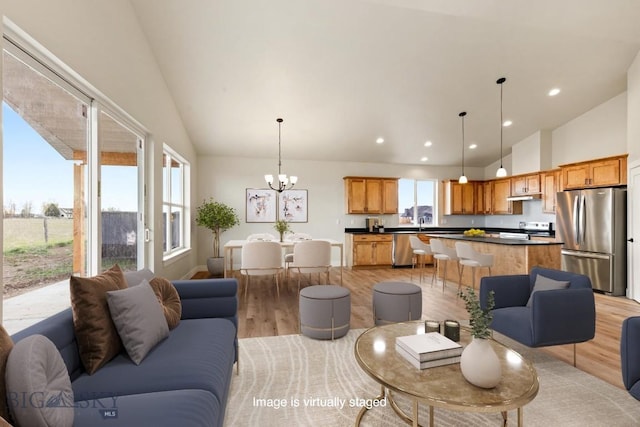 608 Spaniel Ln, Belgrade, MT 59714 - living room featuring light wood-type flooring, high vaulted ceiling, a chandelier, and recessed lighting