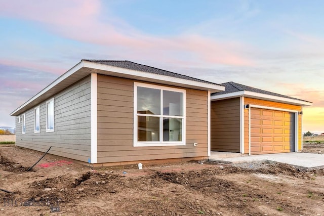 608 Spaniel Ln, Belgrade, MT 59714 - view of side of home with an attached garage and an outbuilding