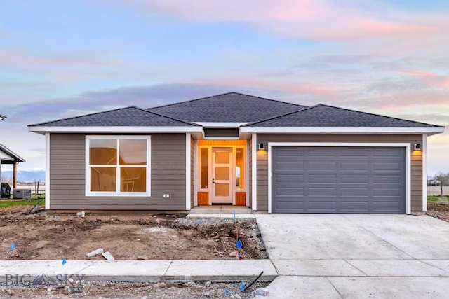 608 Spaniel Ln, Belgrade, MT 59714 - ranch-style house with a garage, driveway, central AC unit, and a shingled roof