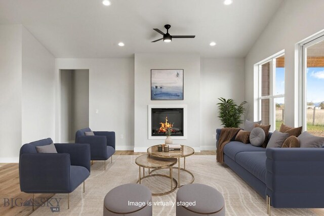 608 Spaniel Ln, Belgrade, MT 59714 - living room with recessed lighting, light wood finished floors, a ceiling fan, a lit fireplace, and baseboards