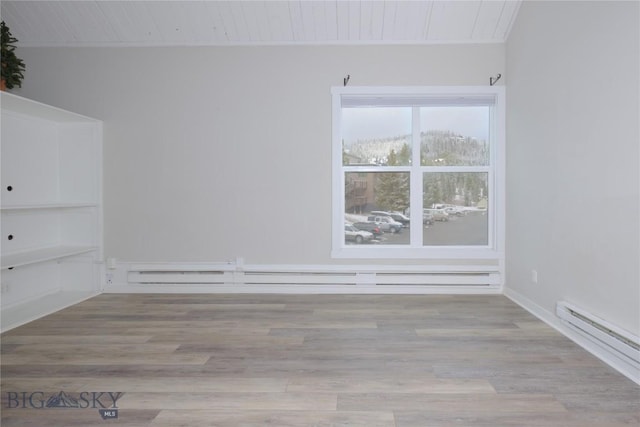 21 Sitting Bull Rd Unit 1226, Big Sky, MT 59716 - spare room featuring wood ceiling, a baseboard heating unit, wood finished floors, and a baseboard radiator