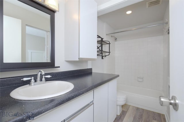 21 Sitting Bull Rd Unit 1226, Big Sky, MT 59716 - bathroom with toilet, vanity, wood finished floors, and washtub / shower combination