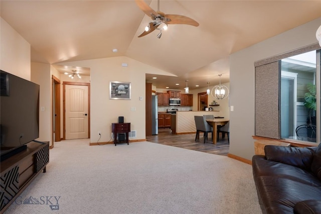 1079 N Cottonwood Rd, Bozeman, MT 59718 - living area with ceiling fan, light colored carpet, vaulted ceiling, baseboards, and a chandelier