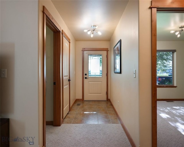 1079 N Cottonwood Rd, Bozeman, MT 59718 - entryway featuring a chandelier, carpet flooring, plenty of natural light, and baseboards
