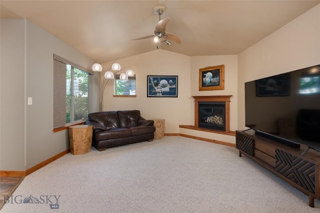 1079 N Cottonwood Rd, Bozeman, MT 59718 - carpeted living room with lofted ceiling, baseboards, a glass covered fireplace, and ceiling fan