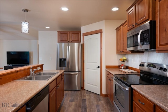 1079 N Cottonwood Rd, Bozeman, MT 59718 - kitchen with appliances with stainless steel finishes, a sink, dark wood-style flooring, brown cabinets, and recessed lighting