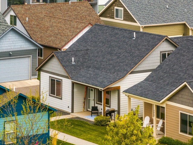 2472 Milkhouse Ave, Bozeman, MT 59718 - view of front facade featuring roof with shingles, an attached garage, and a patio area