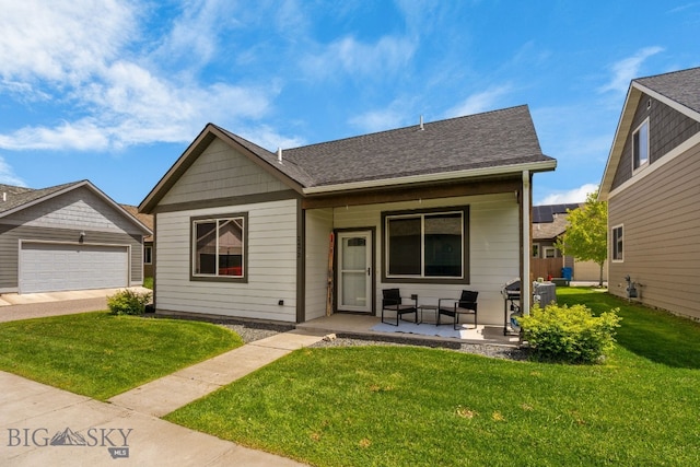 2472 Milkhouse Ave, Bozeman, MT 59718 - bungalow-style home with a front yard, a detached garage, and covered porch