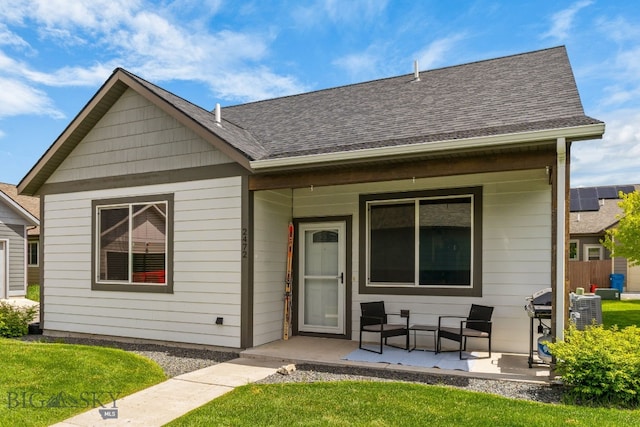 2472 Milkhouse Ave, Bozeman, MT 59718 - bungalow-style home featuring a porch, a shingled roof, and a front lawn
