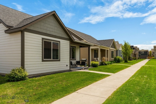 2472 Milkhouse Ave, Bozeman, MT 59718 - rear view of house with a lawn, a patio, and a shingled roof