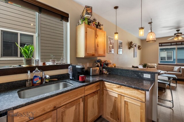 2472 Milkhouse Ave, Bozeman, MT 59718 - kitchen featuring a sink, open floor plan, ceiling fan, a peninsula, and hanging light fixtures