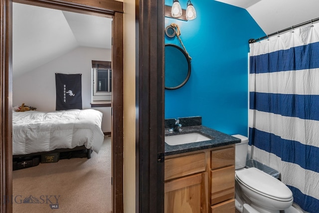 2472 Milkhouse Ave, Bozeman, MT 59718 - ensuite bathroom with lofted ceiling, vanity, toilet, and a shower with shower curtain