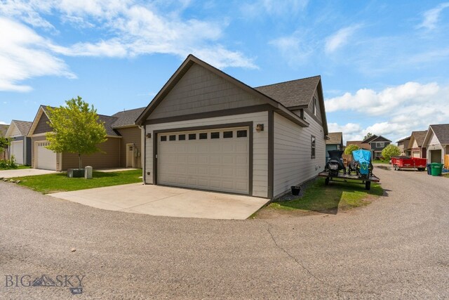 2472 Milkhouse Ave, Bozeman, MT 59718 - view of front of house with a garage, driveway, and roof with shingles