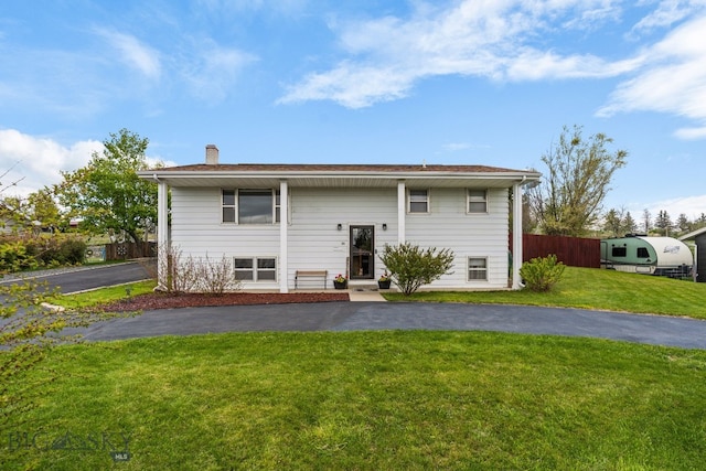 22 Rocky Mountain Dr, Whitehall, MT 59759 - back of property with a chimney and asphalt driveway