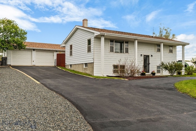 22 Rocky Mountain Dr, Whitehall, MT 59759 - raised ranch featuring a chimney, asphalt driveway, and an outdoor structure