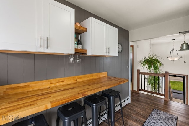 22 Rocky Mountain Dr, Whitehall, MT 59759 - kitchen with open shelves, white cabinets, dark wood-style flooring, a breakfast bar area, and butcher block countertops