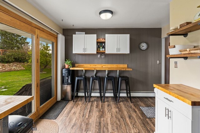 22 Rocky Mountain Dr, Whitehall, MT 59759 - kitchen featuring wood counters, open shelves, dark wood-style floors, a kitchen bar, and white cabinets