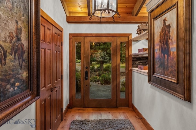 14585 Eagle Eye Way, Gallatin Gateway, MT 59730 - foyer with light wood-type flooring, wooden ceiling with exposed beams, and baseboards
