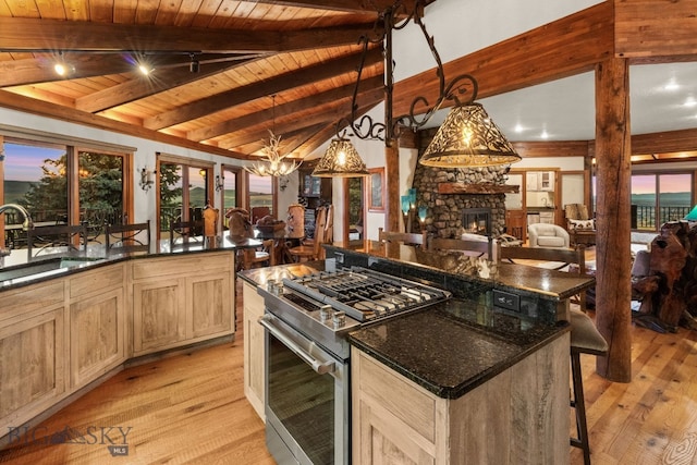 14585 Eagle Eye Way, Gallatin Gateway, MT 59730 - kitchen featuring gas range, wooden ceiling, light wood-type flooring, a sink, and a stone fireplace
