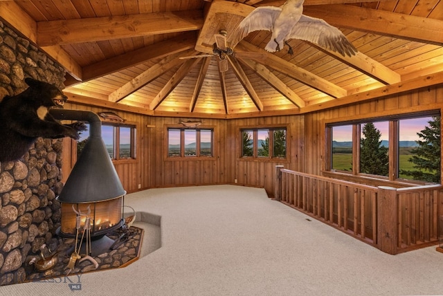 14585 Eagle Eye Way, Gallatin Gateway, MT 59730 - unfurnished room featuring wood ceiling, a wood stove, and carpet flooring