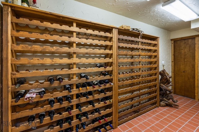14585 Eagle Eye Way, Gallatin Gateway, MT 59730 - wine area with dark tile patterned floors and a textured wall