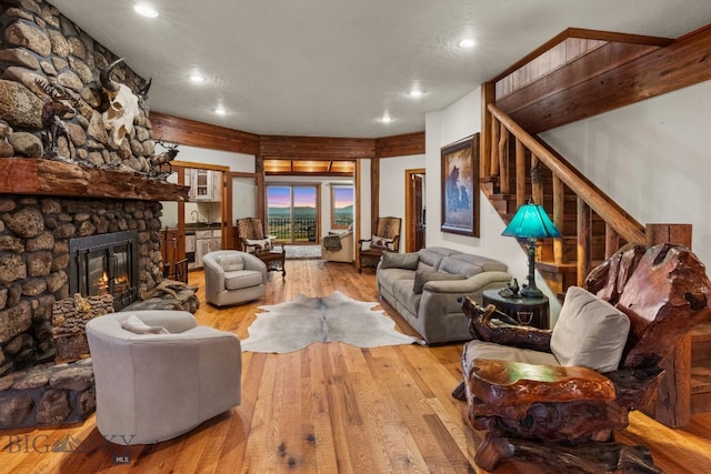 14585 Eagle Eye Way, Gallatin Gateway, MT 59730 - living room with wood-type flooring, recessed lighting, stairway, and a stone fireplace