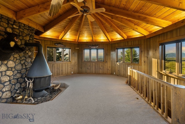 14585 Eagle Eye Way, Gallatin Gateway, MT 59730 - interior space featuring a wood stove, wood ceiling, carpet flooring, and a ceiling fan