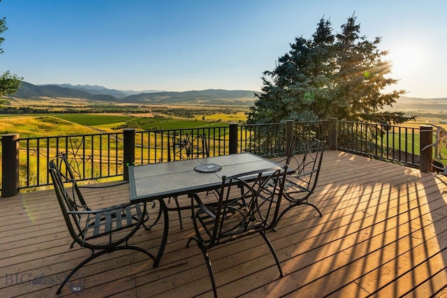 14585 Eagle Eye Way, Gallatin Gateway, MT 59730 - wooden deck with outdoor dining space, a mountain view, and a view of rural / pastoral area