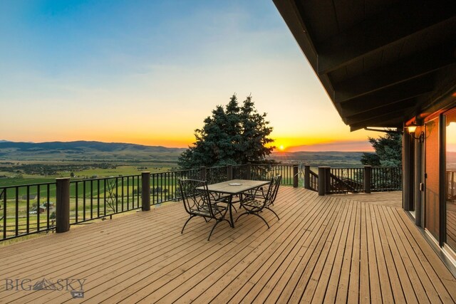 14585 Eagle Eye Way, Gallatin Gateway, MT 59730 - deck at dusk with outdoor dining area and a mountain view
