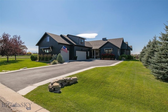 646 Arrow Trl, Bozeman, MT 59718 - modern farmhouse style home featuring asphalt driveway, board and batten siding, a front yard, and an attached garage