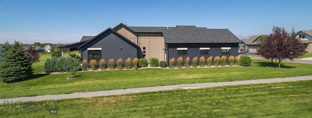 646 Arrow Trl, Bozeman, MT 59718 - view of front facade with board and batten siding and a front lawn